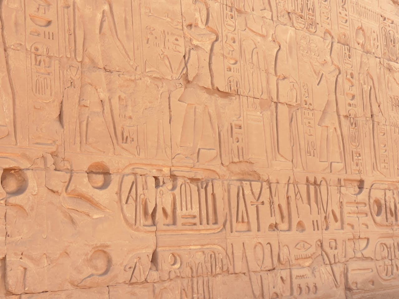 Intricate ancient Egyptian hieroglyphics carved into the historic Karnak Temple wall in Egypt.