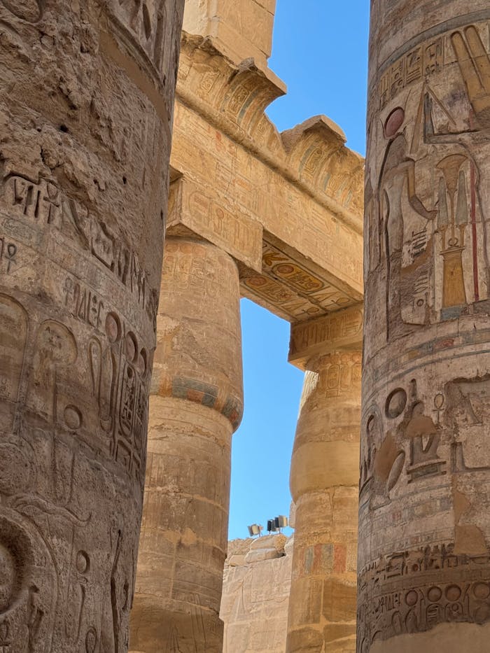 Detailed view of ancient columns with hieroglyphs at Karnak Temple in Luxor, Egypt.